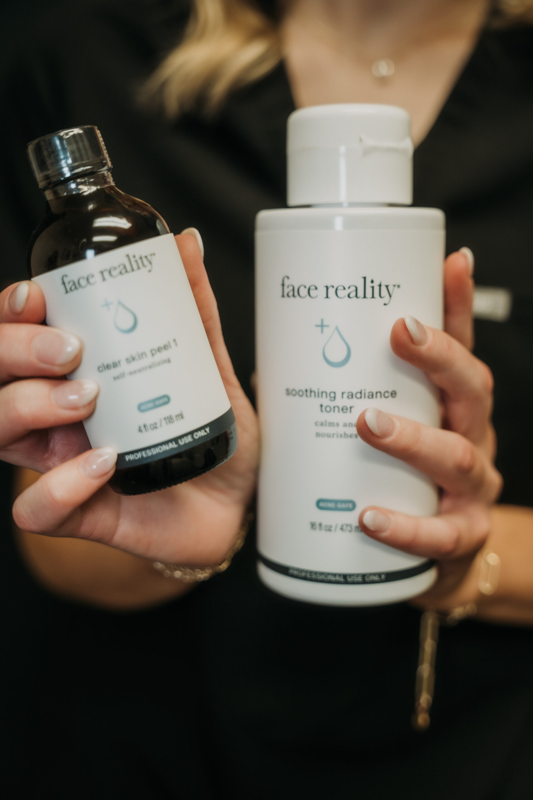Face Reality skincare products held by a Revival provider